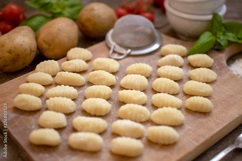 Obraz premium Uncooked fresh homemade gnocchi. Italian cuisine - raw gnocchi, made of potato and flour.