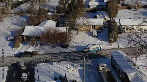 Above view of a small snowy town and busy highway nearby photo