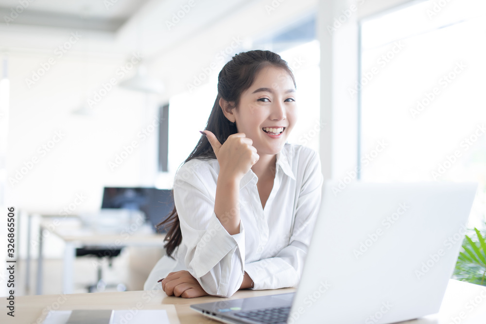 businesswoman happy working using laptop computer in office room businesswoman happy working using laptop computer in office room