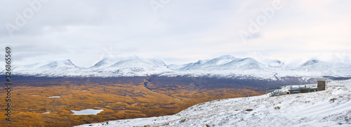 Panoramic view from Nuolja mountain top with Aurora Sky Station and surrounding Abisko national park mountain area.