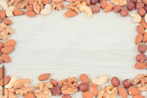 Frame of various nuts and almonds containing healthy natural vitamins and minerals, nutritious eating