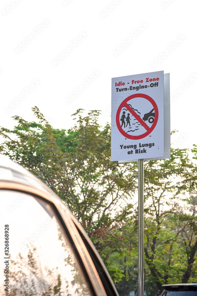 Warning sign in a school parking lot, Free Zone, turn car engine off