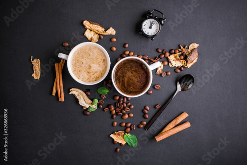 Fragrant coffee of different kinds and varieties, with dried mushrooms and mint leaf on a black background.
