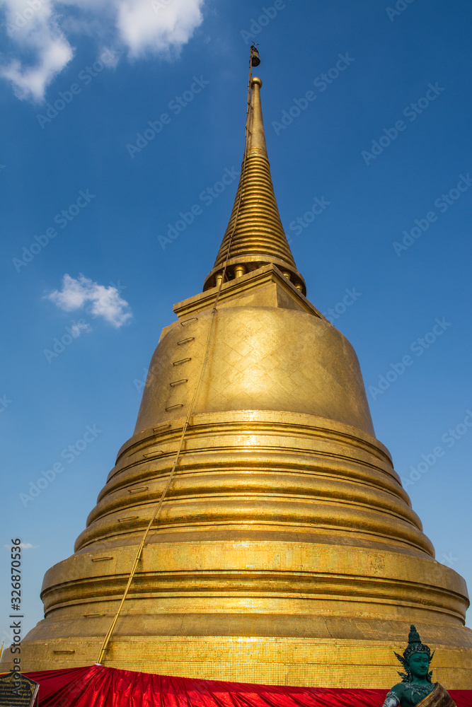Fototapeta premium Phu Khao Thong or Golden mountain is a steep artificial hill inside the Wat Saket compound Bangkok Thailand.