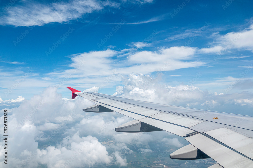 Fototapeta premium Look through the plane window and white cloud and blue sky