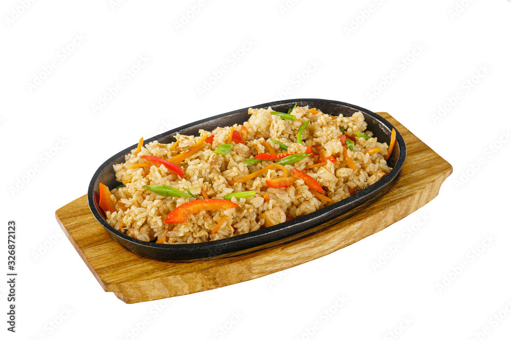 Vegetarian rice with vegetables, peppers, bell peppers, soy meat serving on a hot frying pan, on a wooden board on white isolated background side view. For the menu, restaurant, bar, cafe Vegetarian rice with vegetables, peppers, bell peppers, soy meat serving on a hot frying pan, on a wooden board on white isolated background side view. For the menu, restaurant, bar, cafe
