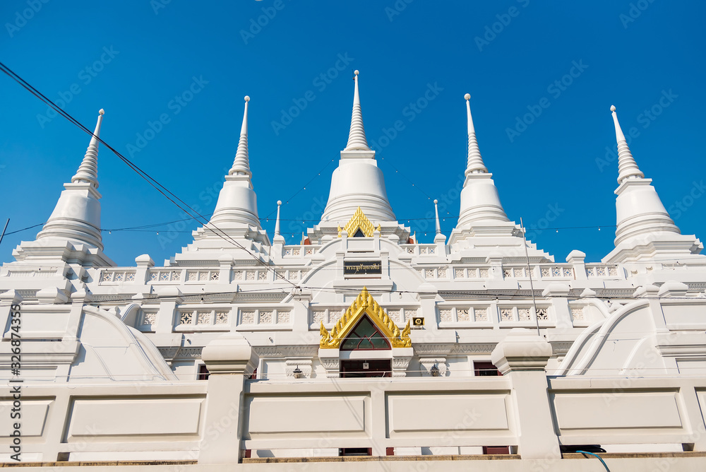 Samut Prakan, Thailand - February,23, 2020 : White Buddhist Pagoda with multiple spires at Wat Asokaram Temple in Thailand