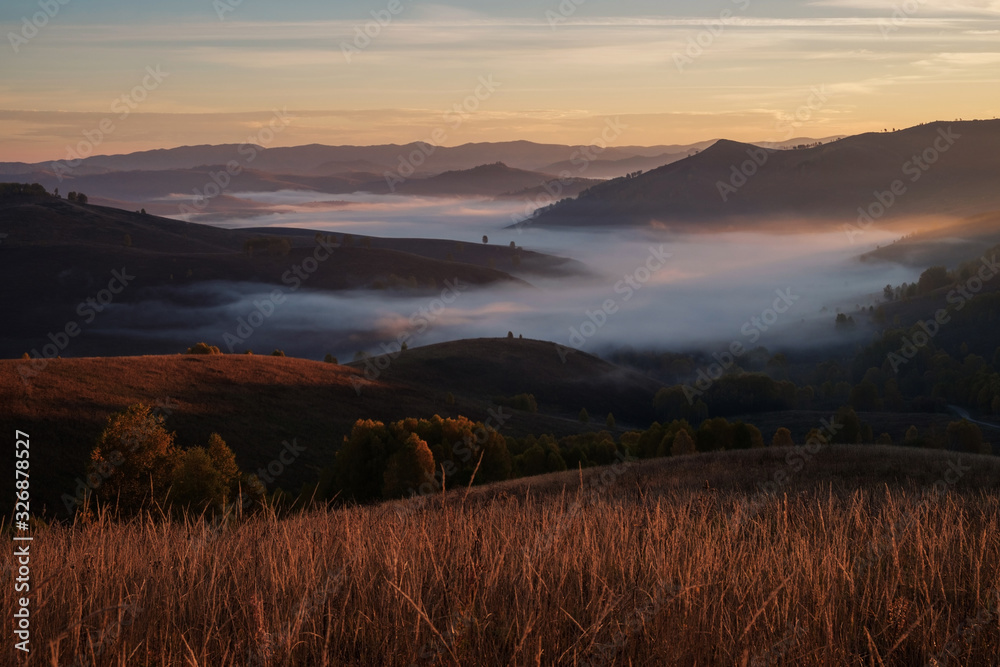 Morning fog in a mountain valley, sunrise. Autumn Altai.