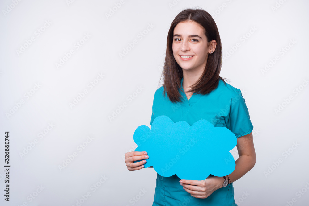 cheerful smiling young woman doctor holding blue cloud bubble sp