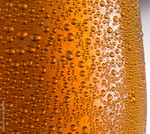 Cooled glass of beer close-up.  Small water drops on cold glass surface.