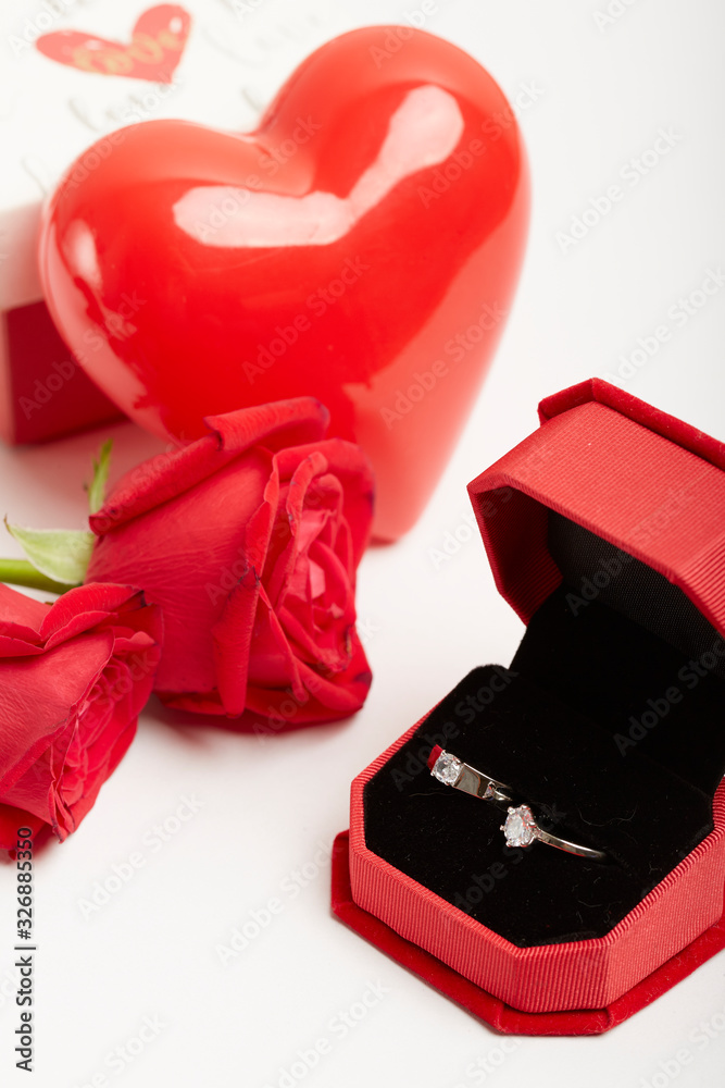 Diamond rings and gift boxes on roses
