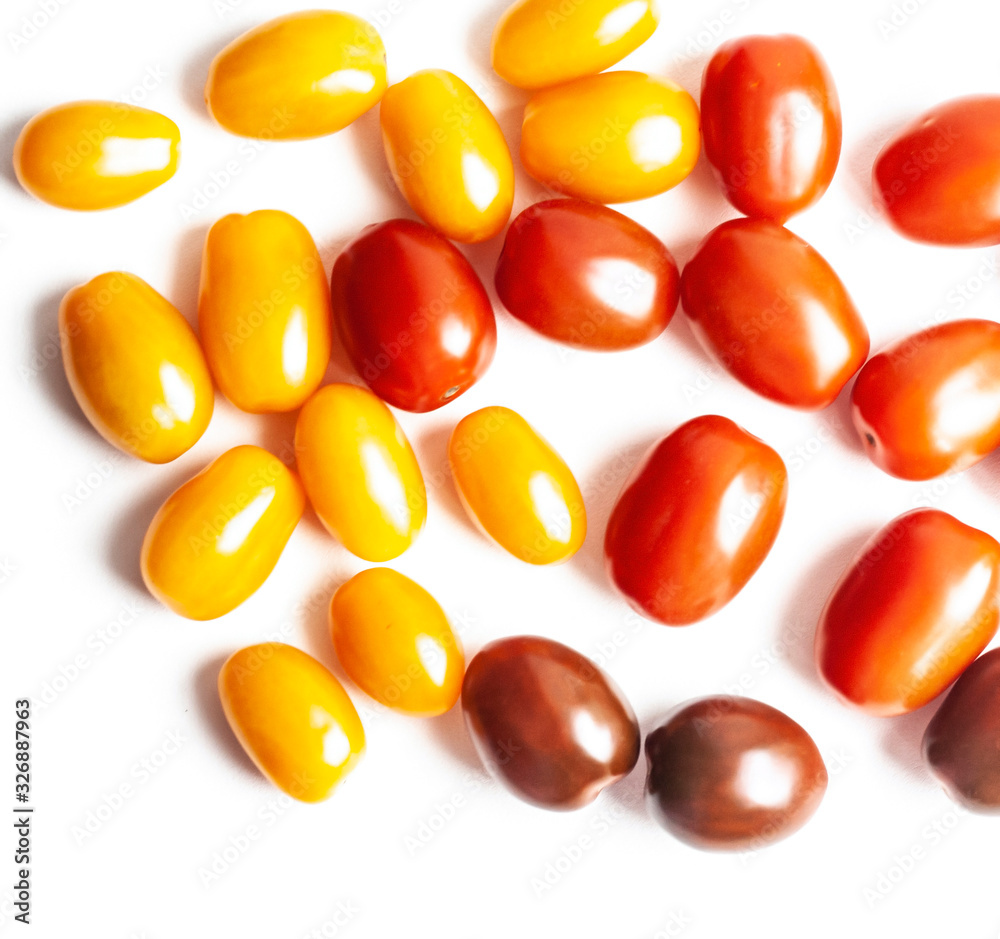Vegetables, red, yellow and dark cherry tomatoes on a white background Vegetables, red, yellow and dark cherry tomatoes on a white background