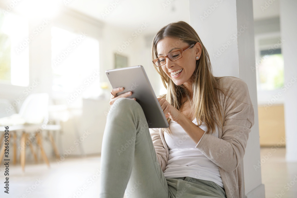 Woman at home relaxing and websurfing with digital tablet Woman at home relaxing and websurfing with digital tablet