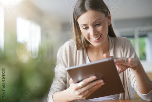 Free Download Portrait of woman at home connected with digital tablet - GFXLoad