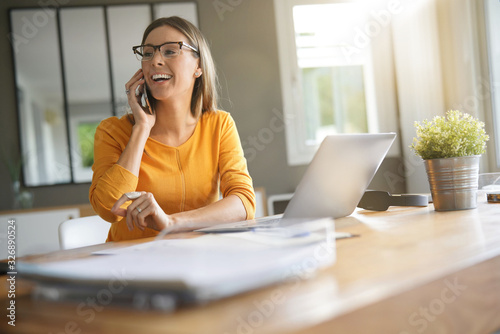 Woman in office talking on phone