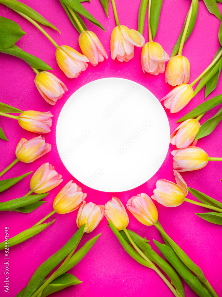 Spring tulips frame, with plate on pink background