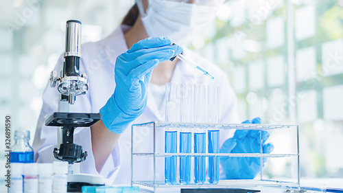 Obraz na płótnie Medical or scientific researcher or man doctor looking at a test tube of clear s
