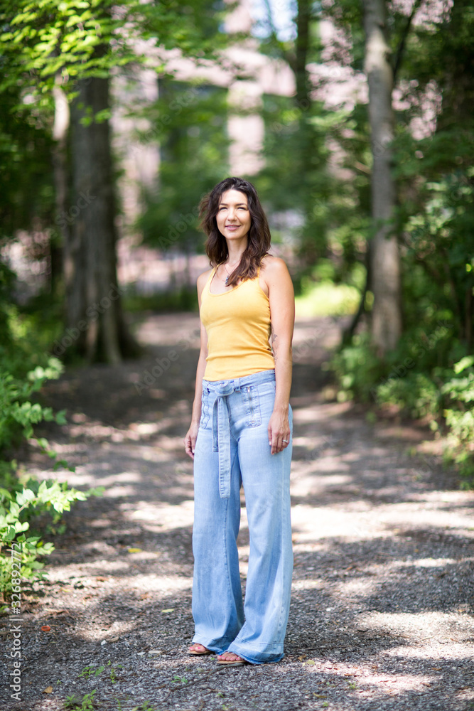 Beautiful Hispanic woman smiling standing in a forest. Beautiful Hispanic woman smiling standing in a forest.