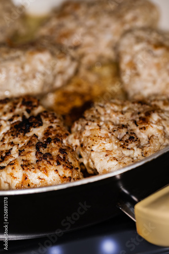 Meat cutlets are fried in a pan. Cooking.