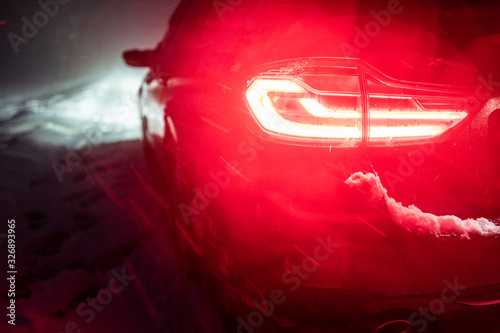 red tail light in a winter snow storm photo