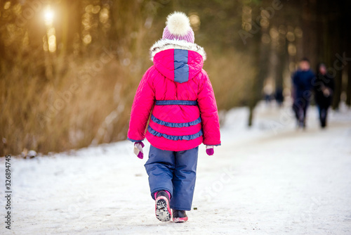 Little girl walking in the winter Park