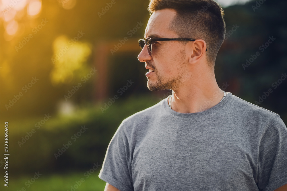 Attractive guy in sunglasses looks away. Portrait of man in sunglasses. Attractive guy in sunglasses looks away. Portrait of man in sunglasses.