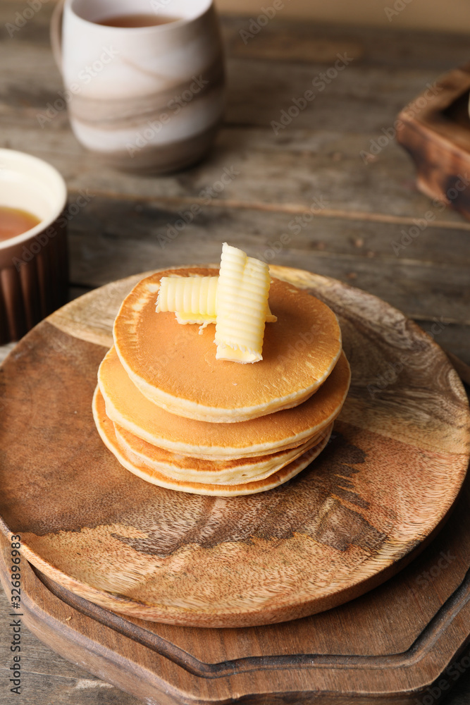 Tasty pancakes with butter on plate