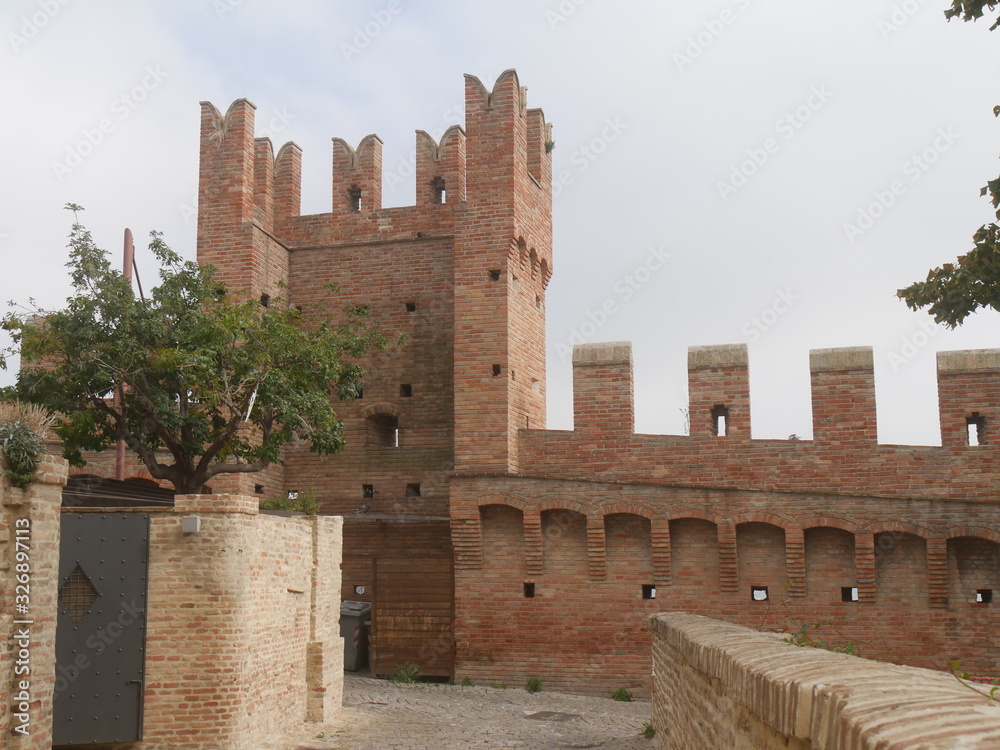 Internal walls with towers and laces around the village of Gradara with the walkway above.