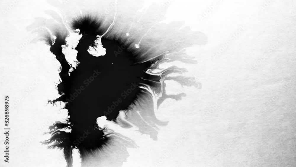 Black ink drops splatters spilling on white background