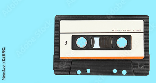 Retro audio tape cassette on a blue background. Top view