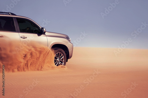Off-road safari on the golden sands of the desert on a car in Walvis Bay. Namibia. SUV breaks through sand dunes in the desert © Yuliia Lakeienko