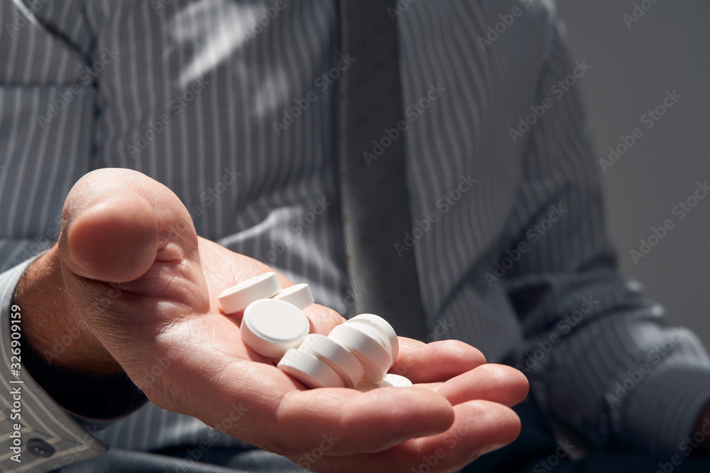 businessman with a pill, hands close view - concept of difficulties, depression, problems, health and stress, risk of modern business businessman with a pill, hands close view - concept of difficulties, depression, problems, health and stress, risk of modern business