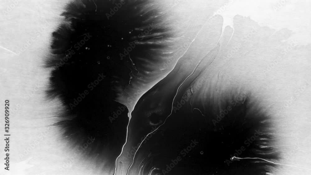 Black ink drops splatters spilling on white background
