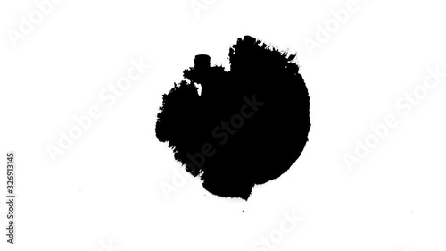 Black ink drops splatters spilling on white background