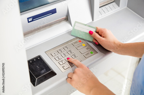 Fotografía Woman using modern ATM nashine - cash withdrawal.