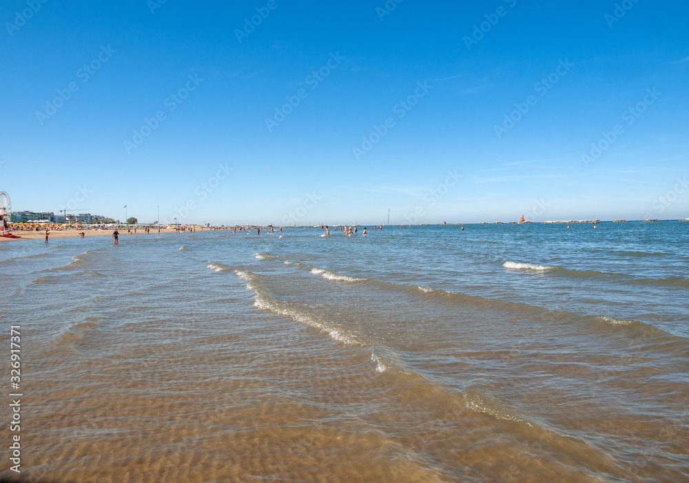 People are resting on a sunny day at the beach in Cesenatico, Italy