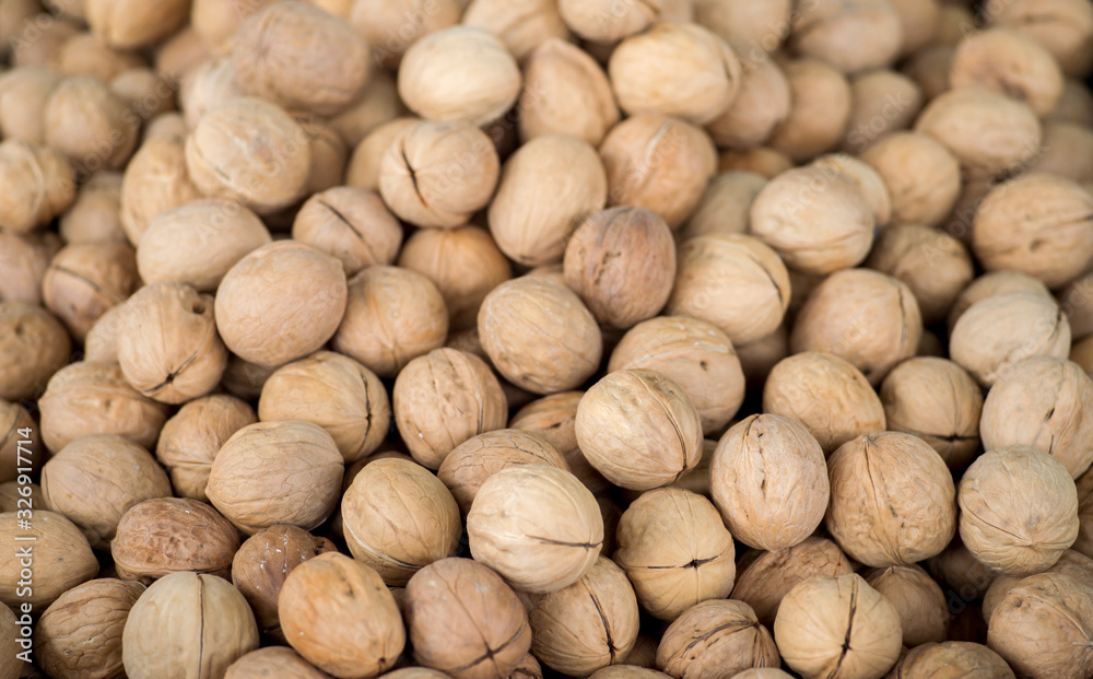 The texture of walnuts on the counter of the store. Background The texture of walnuts on the counter of the store. Background