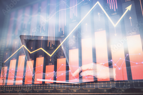 Double exposure of stock market graph with man working on laptop on background. Concept of financial analysis. © peshkova