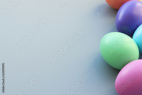 Easter colored eggs painted with bright colors on a gray background. Selective focus.Copy space