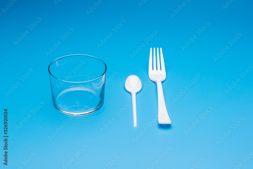 Teaspoon and plastic fork and glass tumbler Teaspoon and plastic fork and glass tumbler