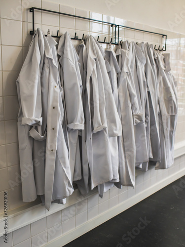 white corridor with white lab coats hanging on a hanger