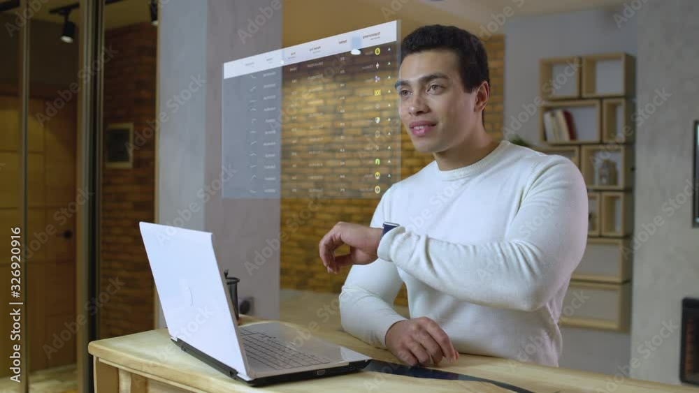 Young man checking hologram with cryptocurrency prices, futuristic tech, AR. Virtual screen, heads up display, augmented reality Young man checking hologram with cryptocurrency prices, futuristic tech, AR. Virtual screen, heads up display, augmented reality