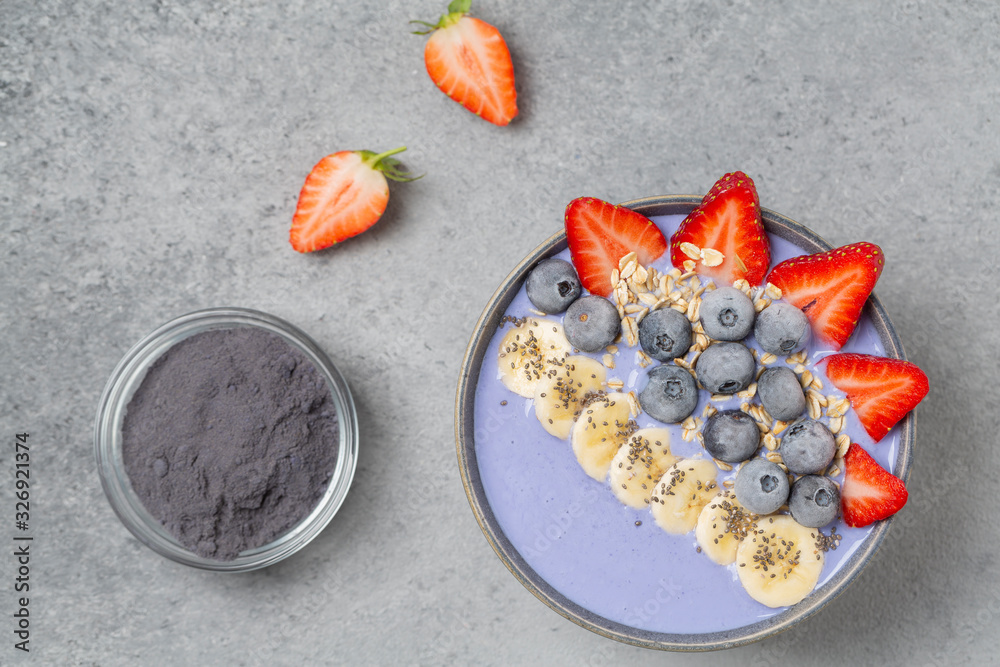 Healthy smoothie bowl with blue Matcha, berries, fruit, granola and Chia seeds. Delicious breakfast