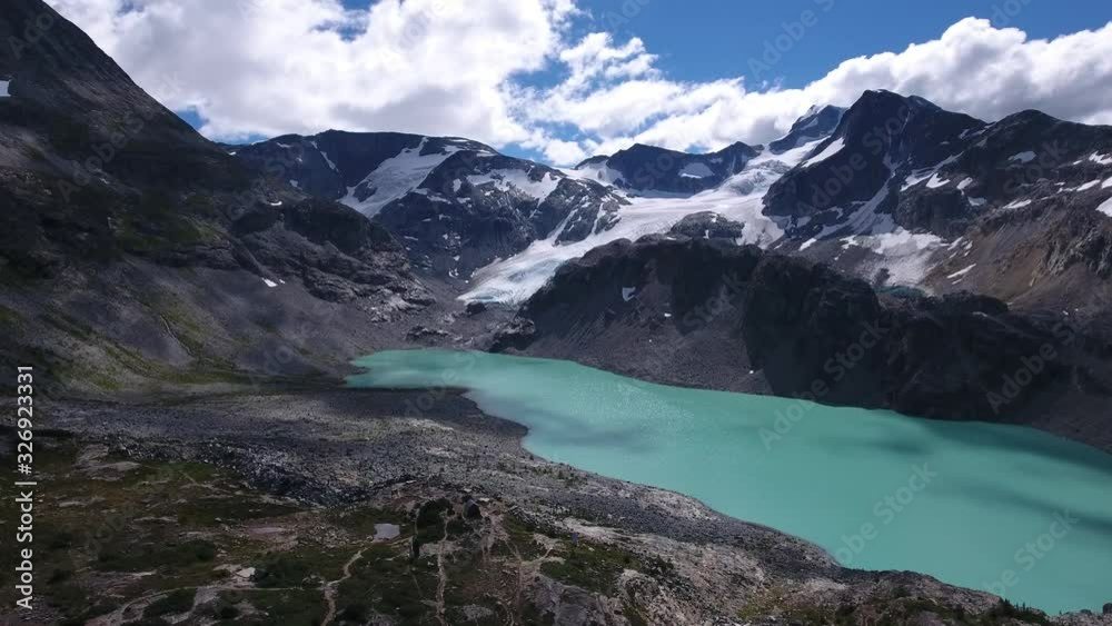 beautiful view of a turquoise lake surrounded by the rocky mountains during summer. Wide drone shot. beautiful view of a turquoise lake surrounded by the rocky mountains during summer. Wide drone shot.