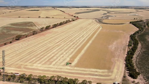 Aerial view of two headers harvesting farmland in drought stricken outback Australia photo