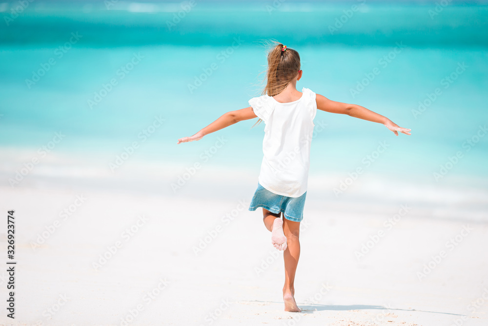 Cute little girl at beach during caribbean vacation Cute little girl at beach during caribbean vacation