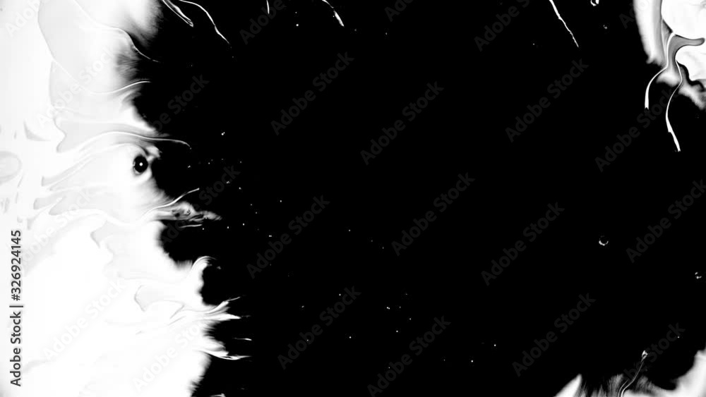 Black ink drops splatters spilling on white background