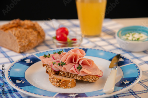 Salami sandwich with cheese spread and organic radish