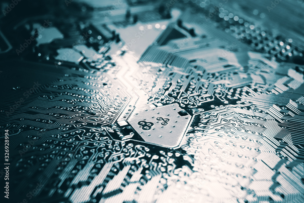 Fototapeta premium Blue electronic mother board circuit close up macro background.