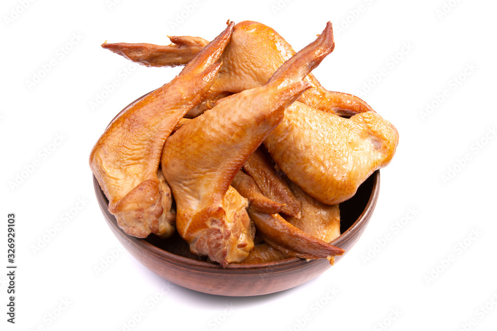 smoked chicken wings, cherry tomatoes in a clay plate on a white isolated background smoked chicken wings, cherry tomatoes in a clay plate on a white isolated background